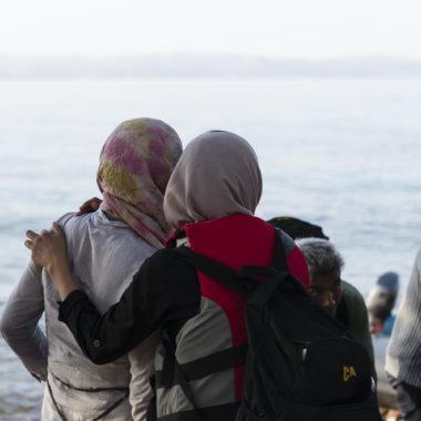 Two women hug after reaching safety in the North Shore of Lesvos.