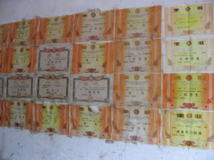 'Good student' certificates pastes on the wall of a rural house