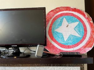 Homemade Captain America shield next to a television