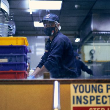 A man wearing mask working at Domino's