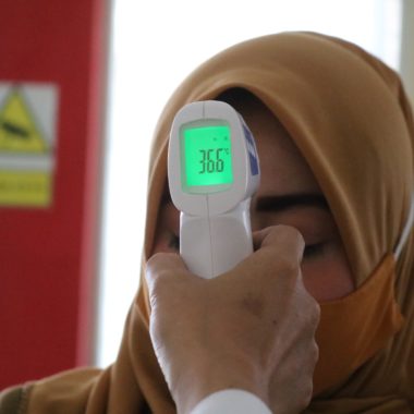 thermo gun to check body temperature as a covid-19 screening