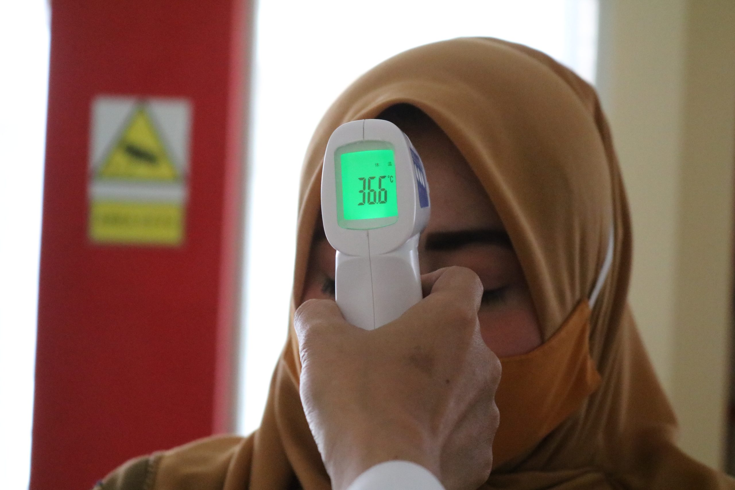 thermo gun to check body temperature as a covid-19 screening