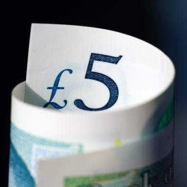 Curled five pound note