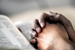 praying hands on bible
