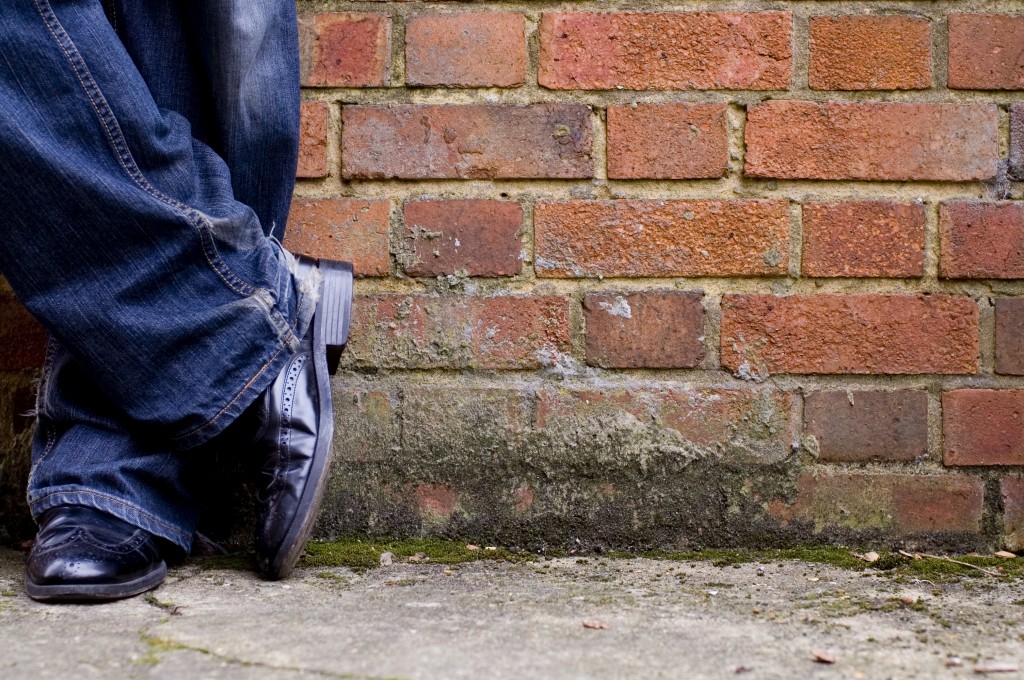 smart shoes leaning against wall